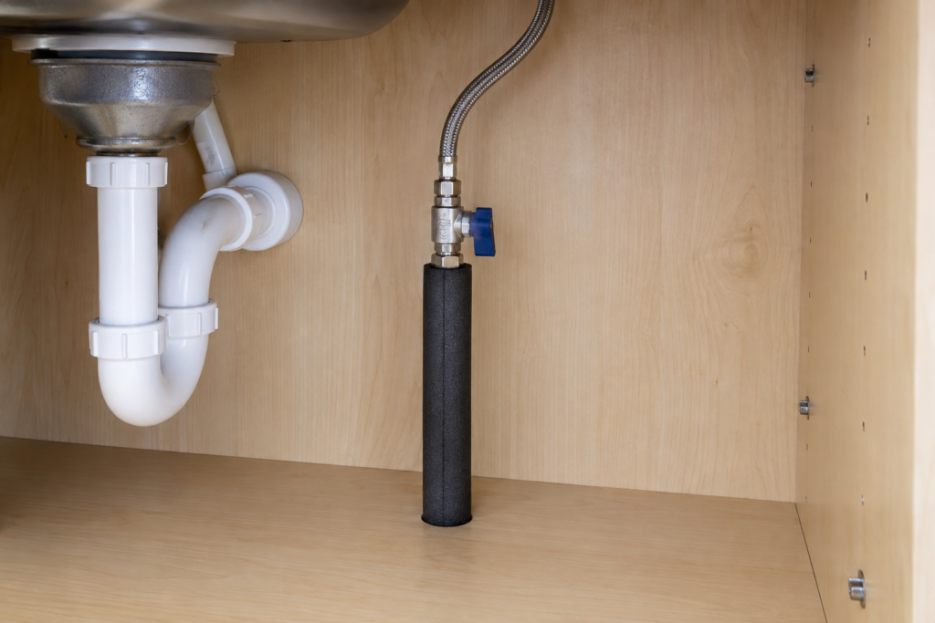 Insulated cold-water pipe beside an accessible shutoff valve.