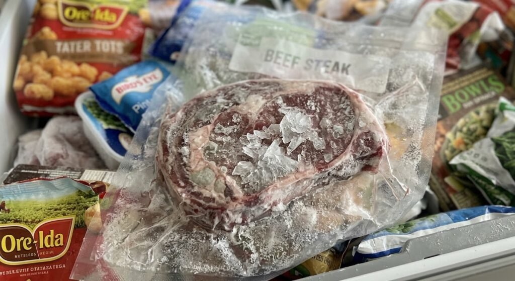 Freezer burn on meat stored too long at the bottom of a freezer drawer